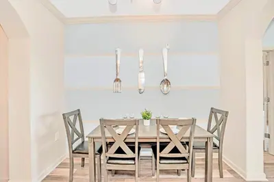 a dining room with a wooden table and chairs at Relaxing 3BR Near Disney - Pool in Orlando
