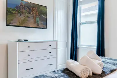 a bedroom with a white dresser and a window at Encore Resort 5 Bedroom Home with Pool 2201 in Orlando