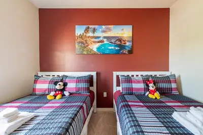 two beds with teddy bears sitting on them in a bedroom at Super Comfy and Spacious 3 Bedroom 15-20 minutes from Disney, with major shopping 4 minutes away in Kissimmee