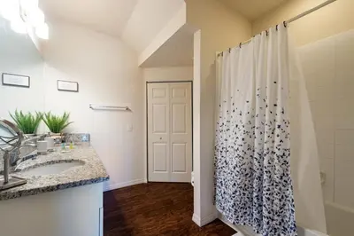 a bathroom with a shower curtain and a sink at Super Comfy and Spacious 3 Bedroom 15-20 minutes from Disney, with major shopping 4 minutes away in Kissimmee