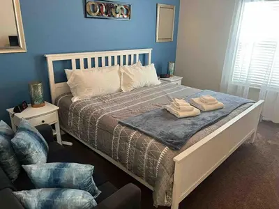 a bedroom with a bed with two towels on it at Super Comfy and Spacious 3 Bedroom 15-20 minutes from Disney, with major shopping 4 minutes away in Kissimmee