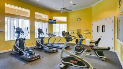 a gym with several exercise bikes in a room at Magical 7BR Resort Pool Home Near Disney & Orlando Attractions in Kissimmee