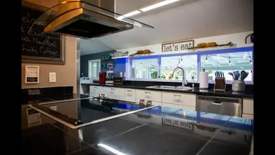 a kitchen with a glass counter top in a kitchen at Family Home with Private Pool Yard Only 24 Mi to Disney in Saint Cloud