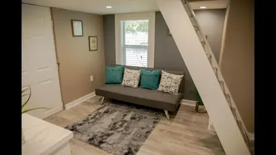 a living room with a couch with blue pillows at Family Home with Private Pool Yard Only 24 Mi to Disney in Saint Cloud
