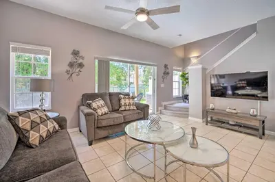 a living room with a couch and a table at 9 Mi to Disney Resort Getaway with Private Patio! in Kissimmee