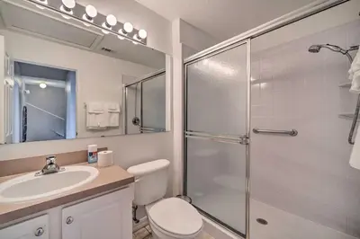a bathroom with a shower and a toilet and a sink at 9 Mi to Disney Resort Getaway with Private Patio! in Kissimmee