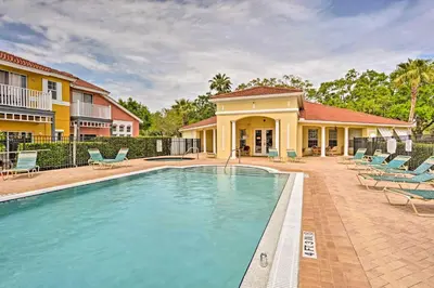 a swimming pool in front of a house at 9 Mi to Disney Resort Getaway with Private Patio! in Kissimmee