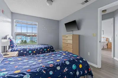 a bedroom with a bed and a tv in it at Poinciana Paradise in Kissimmee