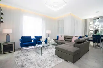 a living room with a couch and blue chairs at Gorgeous 4Bd w/ Pool Close to Disney @ Storey Lake 4289 in Kissimmee