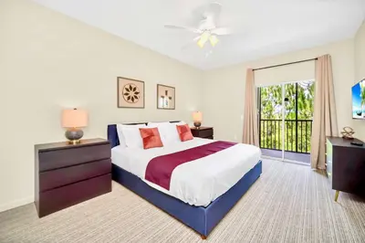 a bedroom with a large bed and a window at 3BR Condo with Pool - Near Disney in Orlando