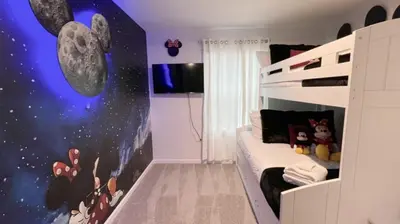 a bedroom with a bunk bed with a mickey mouse mural at NEW! Solara Pool Home 6 Miles to Disney in Kissimmee