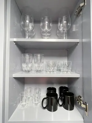 a row of glasses on shelves in a kitchen at Lovely 1 bedroom Condo with pool in Orlando