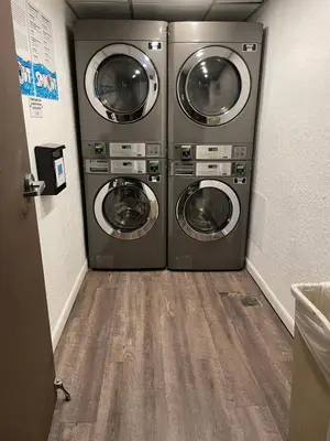 two washer and dryer machines in a laundry room at Lovely 1 bedroom Condo with pool in Orlando