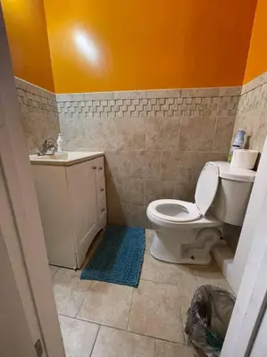a bathroom with a toilet and a sink at The Piano House in Orlando