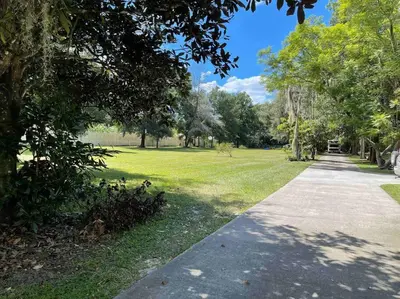 a path in a park with trees and grass at The Piano House in Orlando