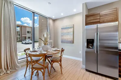 a dining room with a table and a refrigerator at Cozy Home Resort Community Disney 5 Min in Orlando