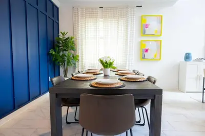 a dining room with a wooden table and chairs at Private Vacation Home at Storey Lake, Orlando Florida in Kissimmee