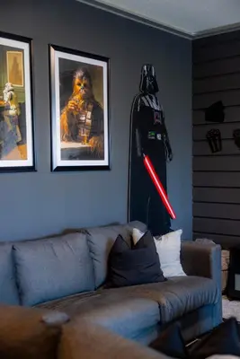 a living room with a couch and a star wars picture at Private Vacation Home at Storey Lake, Orlando Florida in Kissimmee