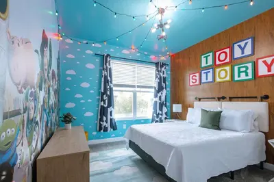 a bedroom with a bed and some signs on the wall at Private Vacation Home at Storey Lake, Orlando Florida in Kissimmee