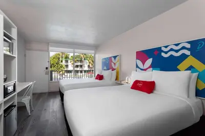 two beds in a room with a window at Baymont by Wyndham Orlando Lake Buena Vista South in Kissimmee