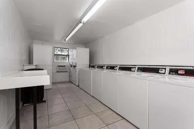 a large kitchen with white cabinets and a sink at Baymont by Wyndham Orlando Lake Buena Vista South in Kissimmee