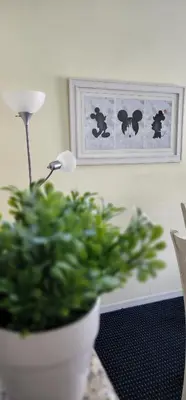 a potted plant sitting on a table next to a lamp at My Home in Orlando in Kissimmee