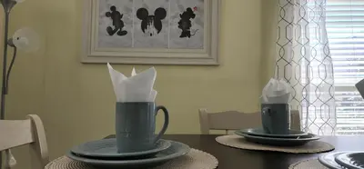 a table with two vases with napkins on it at My Home in Orlando in Kissimmee