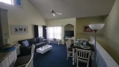 a living room with a couch and a dining room at My Home in Orlando in Kissimmee