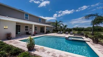 a swimming pool in the backyard of a house at Elegant Fun Vacation Home at Encore Resort 7529 in Orlando