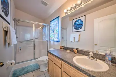 a bathroom with a sink and a shower and a toilet at 10 Mi to Disney and Heated Pool Florida Abode! in Orlando