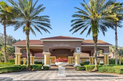 a resort with palm trees in front of a building at 3 Bedrooms 25 Bathrooms Encantada 3091 Yl in Orlando