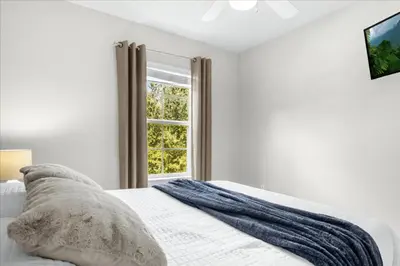 a white bedroom with a bed and a window at 3 Bedrooms 25 Bathrooms Encantada 3091 Yl in Orlando