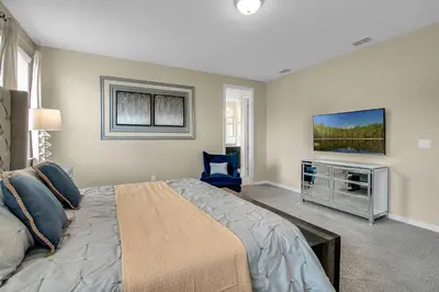 a bedroom with a large bed and a flat screen tv at 7 Bedrooms 65 Bathrooms Solara 9024 Fk in Orlando