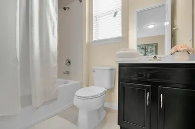 a bathroom with a white toilet and a sink at 7 Bedrooms 65 Bathrooms Solara 9024 Fk in Orlando
