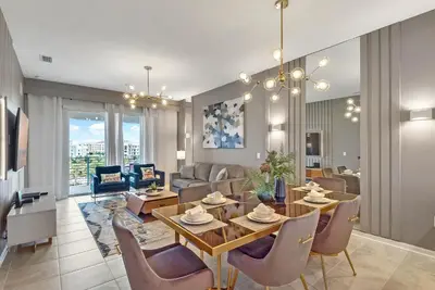 a dining room and living room with a table and chairs at 2 Bedrooms 2 Bathrooms Storey Lake 3150-404 Pc in Kissimmee