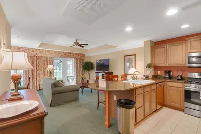 a kitchen with a table and a living room at 3 Bedrooms 25 Bathrooms Reunion Resort 1589 Hc in Orlando