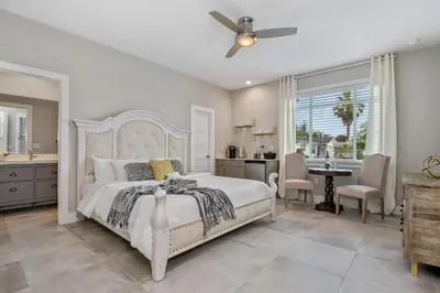 a bedroom with a white bed and a dining room at Centrally Located Guest Suite Retreat in Orlando