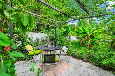 a patio with a table and chairs under a pergola at Centrally Located Guest Suite Retreat in Orlando