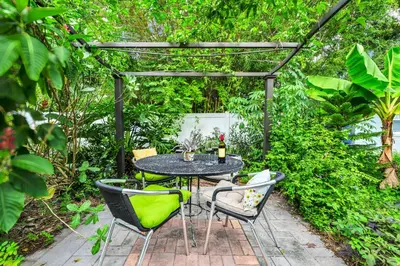 a patio with a table and chairs under a pergola at Centrally Located Guest Suite Retreat in Orlando