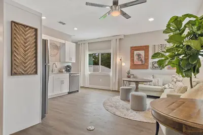 a living room with a table and a kitchen at 5Bd 4Bath villa, amazing outdoor space, pet friendly in Orlando