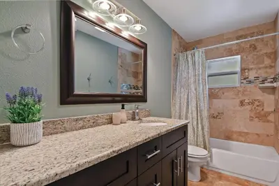 a bathroom with a sink and a mirror at 5Bd 4Bath villa, amazing outdoor space, pet friendly in Orlando