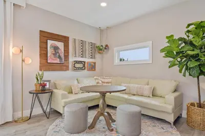 a living room with a couch and a table at Bohemian Retreat in the Heart of Orlando in Orlando