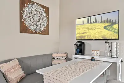 a living room with a couch and a table at Bohemian Retreat in the Heart of Orlando in Orlando