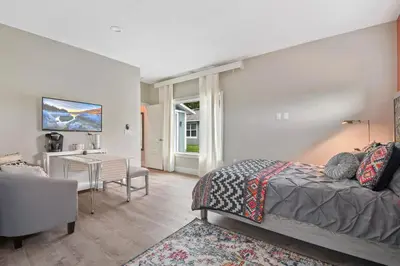 a bedroom with a bed and a desk in a room at Bohemian Retreat in the Heart of Orlando in Orlando