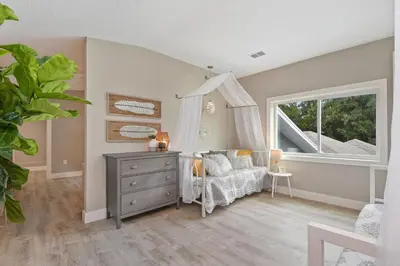 a bedroom with a bed and a dresser and a window at Bohemian Retreat in the Heart of Orlando in Orlando