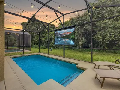 a swimming pool with a tv in a house at Marvelous Magical House: Amazing Themes and Pool, 5mi Disney in Kissimmee