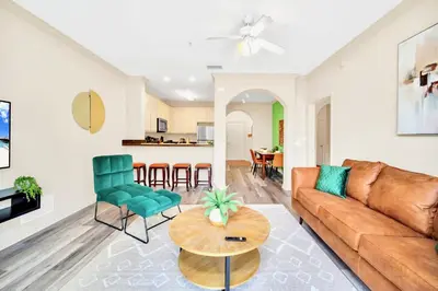 a living room with a couch and a table at 3BR Condo with Pool Close to Disney in Orlando