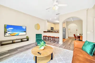 a living room with a couch and a table at 3BR Condo with Pool Close to Disney in Orlando