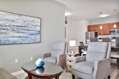 a living room with a couch and chairs and a table at 3 Bed Penthouse Near Convention Center! condo in Orlando