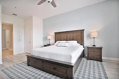 a bedroom with a large bed and two night stands at 3 Bed Penthouse Near Convention Center! condo in Orlando